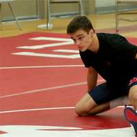 <p>A Byram Hills wrestler warms up for a match.</p>