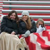 <p>Fans try to stay warm in the stands Thursday in Bedford.</p>