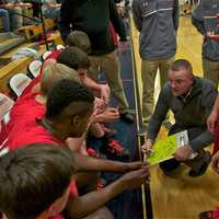 <p>TZ coach George Gaine talks to his team during a timeout.</p>