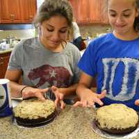 <p>Students work with a cookie dough filling as part of making a ganache cake.</p>