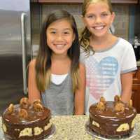 <p>Proud bakers at the end of summer camp show off their creations.</p>