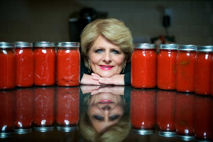 Jacqueline Ruby of Waccabuc, N.Y. poses with some of her homemade sauces.