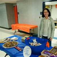 <p>A volunteer sells snacks at the concession stand.</p>