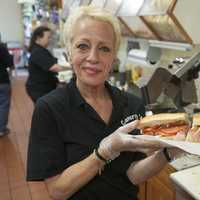 <p>An employee prepares an Italian combo.</p>