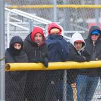 <p>Spectators try to keep warm on a chilly spring day.</p>