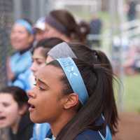 <p>Ursuline players cheer from the dugout.</p>