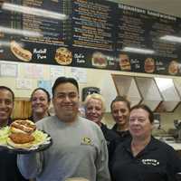 <p>Cameron&#x27;s Deli Brewster Manager Amando Ochoa (center) and staff with the deli&#x27;s tradmark sandwich - the Cluck&#x27;en Russian.</p>