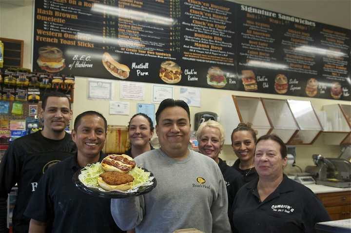 Cameron&#x27;s Deli Brewster Manager Amando Ochoa (center) and staff with the deli&#x27;s tradmark sandwich - the Cluck&#x27;en Russian.