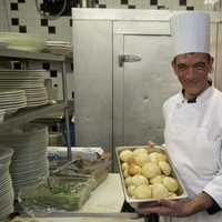 <p>A chef prepares freshly baked rolls at the restaurant.</p>