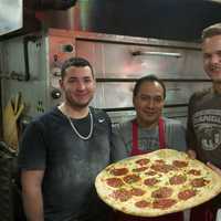 <p>The staff at Napoli&#x27;s Pizza shows off a Margherita pie.</p>