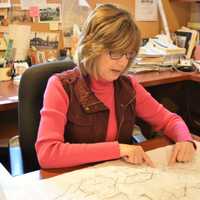 <p>Architect Linda Del Nobile Menze reviewing a blueprint in her Park Ridge office.</p>