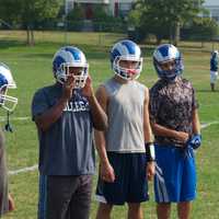 <p>Coach Ron Santavicca (R) has the attention of players as he talks punt return.</p>