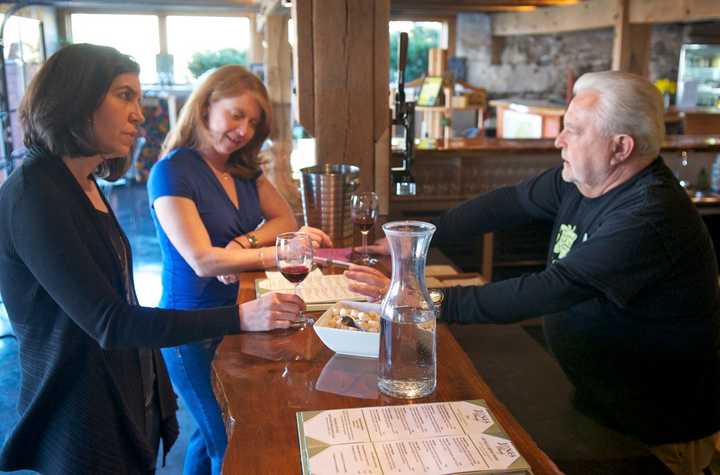 Wine lovers enjoy a taste at Jones Family Farms Winery in Shelton.