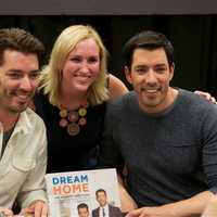 <p>Jonathan (L) and Drew Scott (R) pose with a fan at Monday&#x27;s book signing.</p>