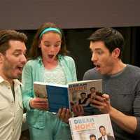 <p>The Property Brothers - Jonathan Scott (L) and Drew Scott - clown around with a fan at Monday&#x27;s book signing.</p>