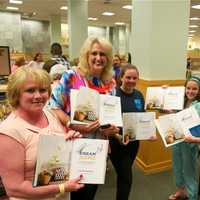 <p>Property Brothers fans show off their freshly signed books at Monday night&#x27;s book signing party at Barnes &amp; Noble in White Plains.</p>