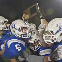 <p>Haldane players hoist the Section 1 Class D championship plaque after beating Tuckahoe Friday at Mahopac.</p>