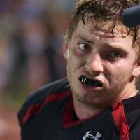 <p>A Rye player gets a rest as he talks to a coach on the sideline at Friday&#x27;s game.</p>