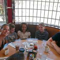 <p>A happy family of five enjoys a meal at the Red Line Diner.</p>