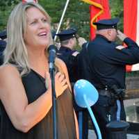 <p>Sheri Marino sings the national anthem.</p>