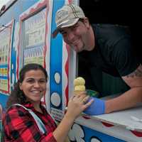 <p>Owner Michael Fertucci serves up ice cream cones at a recent birthday party.</p>