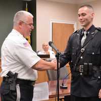 <p>Hillsdale Police Chief congratulates new Patrolman Corey Rooney.</p>