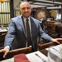 <p>Ulash Geckil, manager, in the new Cinar Turkish Restaurant in Emerson.</p>