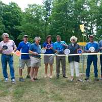 <p>County Executive Marcus Molinaro cuts the ribbon at Wednesday's grand opening of the Wilcox Memorial Park Disc Golf Course.</p>