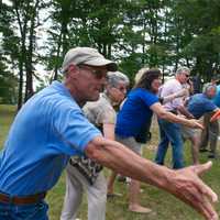 <p>Guests at the ribbon cutting try their hand throwing a disc.</p>