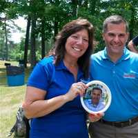 <p>State Sen. Sue Serino and Dutchess County Executive Marcus Molinaro hold up a disc with a photo of Molinaro.</p>