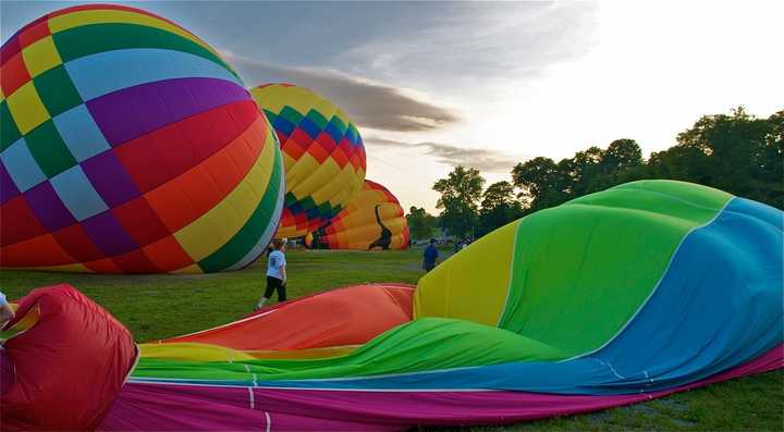 Balloons are inflated for a sunrise mass launch the 2013 HV Balloon Festival.