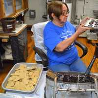 <p>Linda Manzo of Rochelle Park hand dipping Graham crackers in homemade dark chocolate.</p>