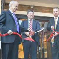 <p>Sideras, joined by the mayor and his father, cuts the ribbon on the River Edge Diner.</p>