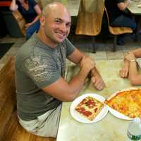 <p>Mark Delahanty (L), of Exact Fit Seamless Gutters, enjoying pizza at Cacciatori.</p>