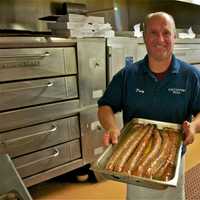 <p>Manager Patsy Femia shows off some of the restaurant&#x27;s freshly made sausage.</p>