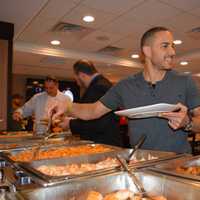 <p>Guests mingle and enjoy the buffet provided by the diner.</p>