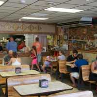 <p>The dining area inside Cacciatori Pizza.</p>