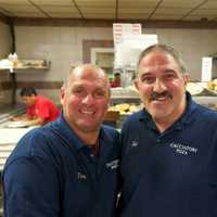 <p>Cacciatori owner Sal Triarsi (R) and manager Patsy Femia make sure their customers feel at home.</p>