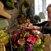 <p>Annabel Green Flowers owner Wendy Manes prepares arrangements for Mother&#x27;s Day in her Wilton shop.</p>