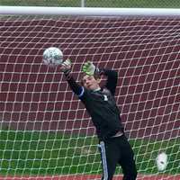 <p>Carmel keeper Brian Sposato goes high to make a save in a loss to Brewster Saturday at Carmel.</p>