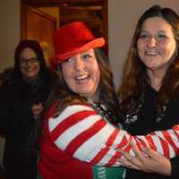 <p>Fair Lawn Human Services Coordinated Liz Maresca as Santa&#x27;s Helper hugs Nicole DeFontes, best friend Kristine Ligierri looks on.</p>