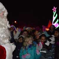 <p>Santa hands out candy canes at Christmas on Vanore.</p>