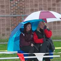 <p>Spectators stay dry at Friday&#x27;s meet.</p>