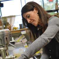 <p>Paula Wozniak working on a Wheatgrass Shot, step one.</p>