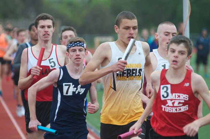 Runners compete in the boys 4x400 Friday at the Joe Wynne Somers Lions Club Track &amp; Field Invitational.