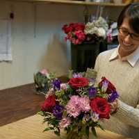 <p>Courtney Sedor works on a floral arrangement in her Beacon shop.</p>