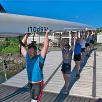 <p>Rowers carry an eight-man scull to the waterfront at the HRRA.</p>