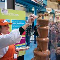 <p>Strawberries are dipped in chocolate at Sunday&#x27;s Chocolate Expo.</p>