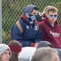 <p>Harrison fans keep warm at a chilly football game.</p>