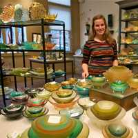 <p>Kaelyn Haggerty of Hudson Beach Glass with some of the store&#x27;s signature spike bowls.</p>